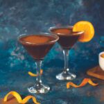 two Chocolate Orange Espresso Martinis with orange peel