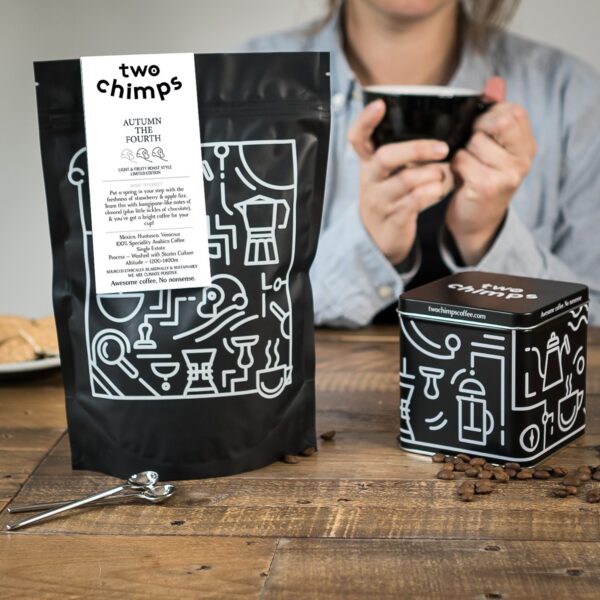 limited-edition two chimps coffee with tin and lady drinking from a black cup