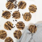 Espresso biscuits on a white background with chocolate chips and a blue tea towel