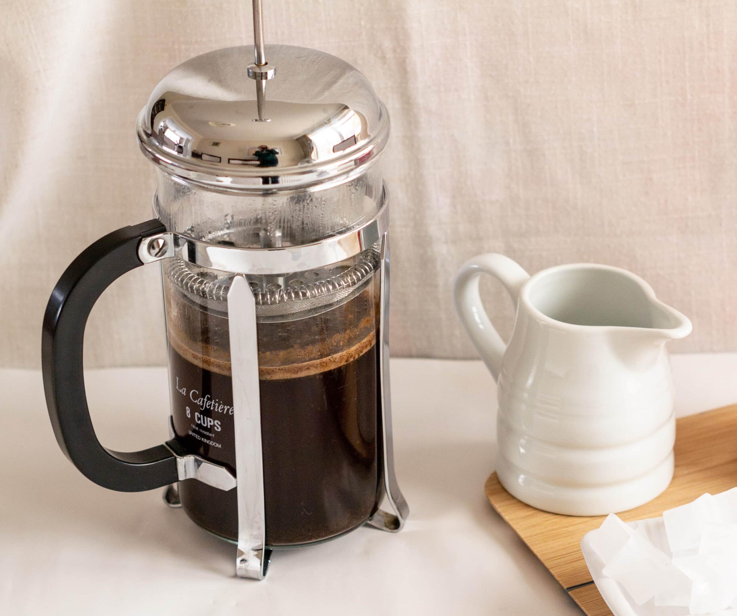 Small cafetiere with coffee and milk jug