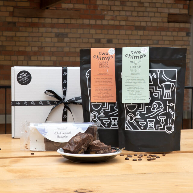 Gift Box and two bags of coffee on a table with brownies