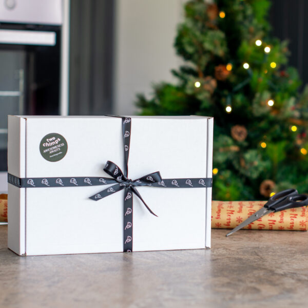 Gift Box on table next to Christmas wrapping paper