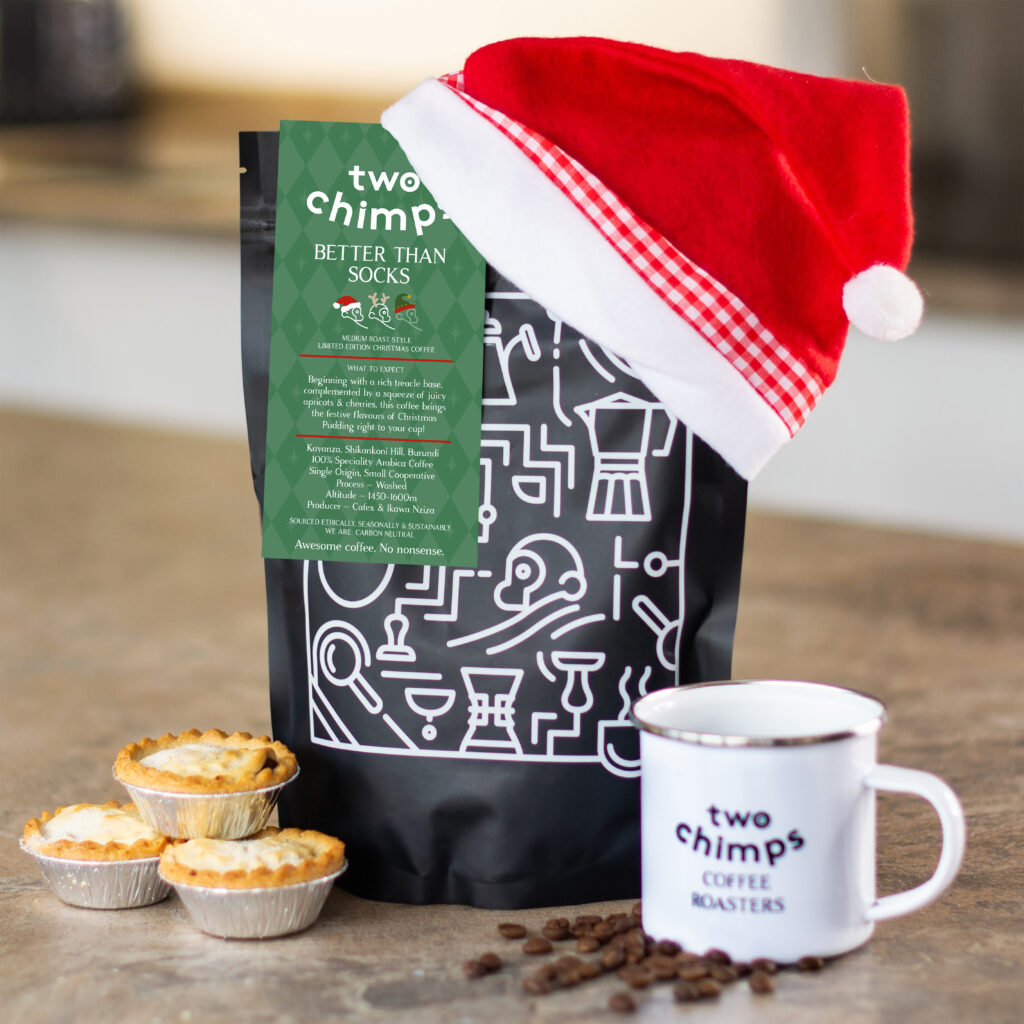 Christmas coffee on a table with a mug and mince pies