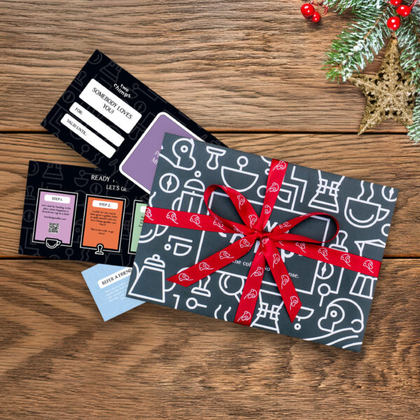 Two Chimps Christmas Voucher tied with red ribbon