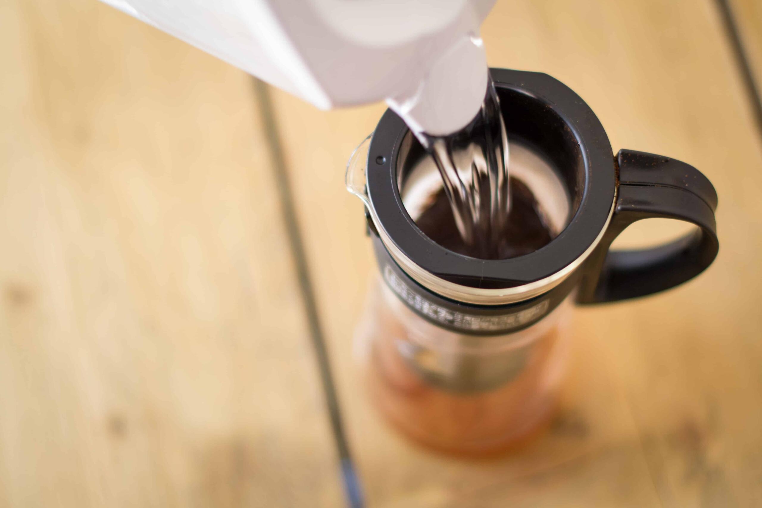 water being poured into cold brew coffee pot