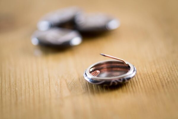 a two chimps badge upside down to see the pin