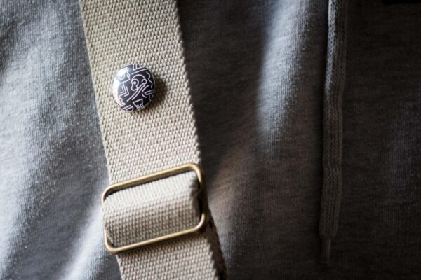 two chimps badge on a bag strap