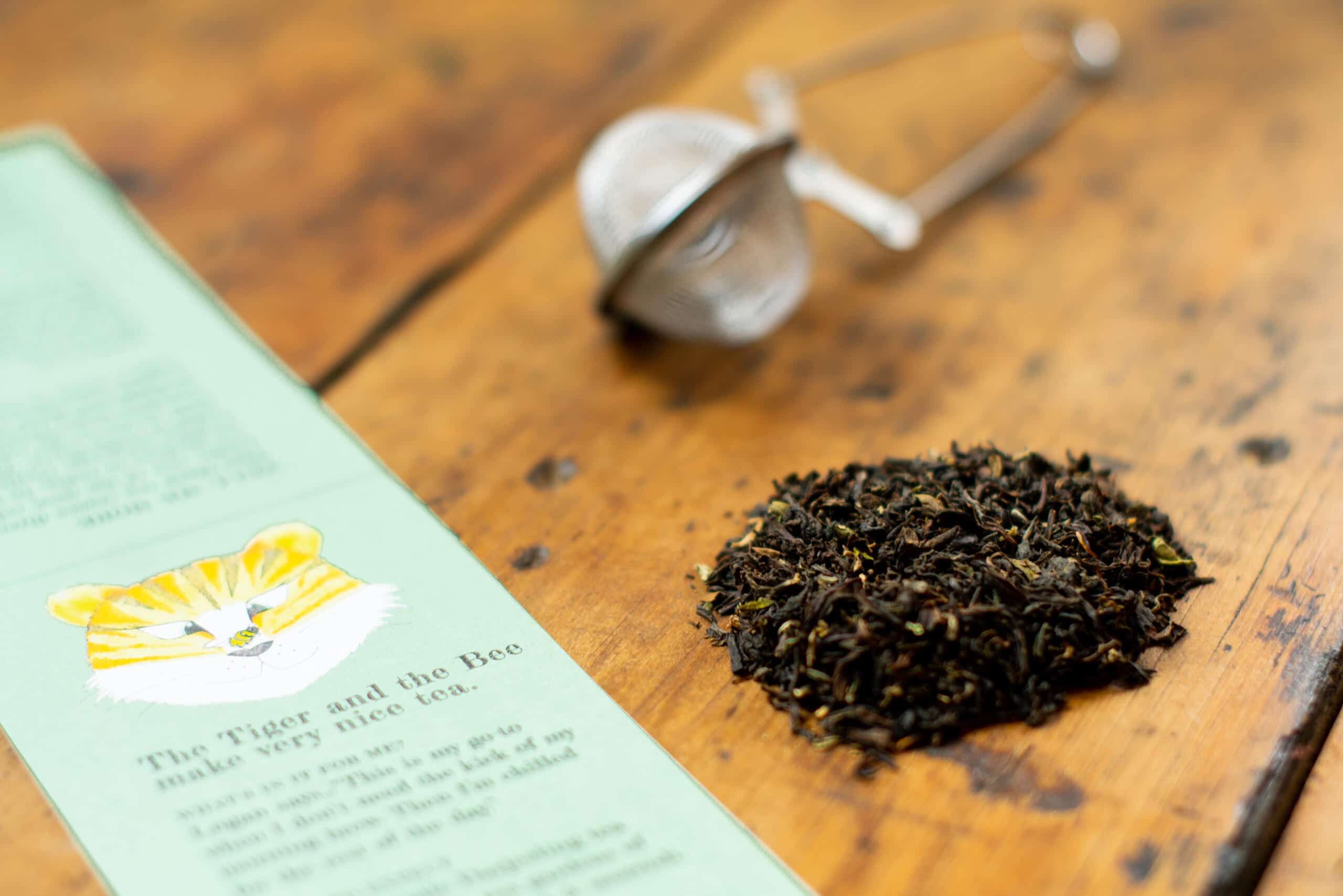 Loose leaf Darjeeling tea from Two Chimps besides tea label and infuser 