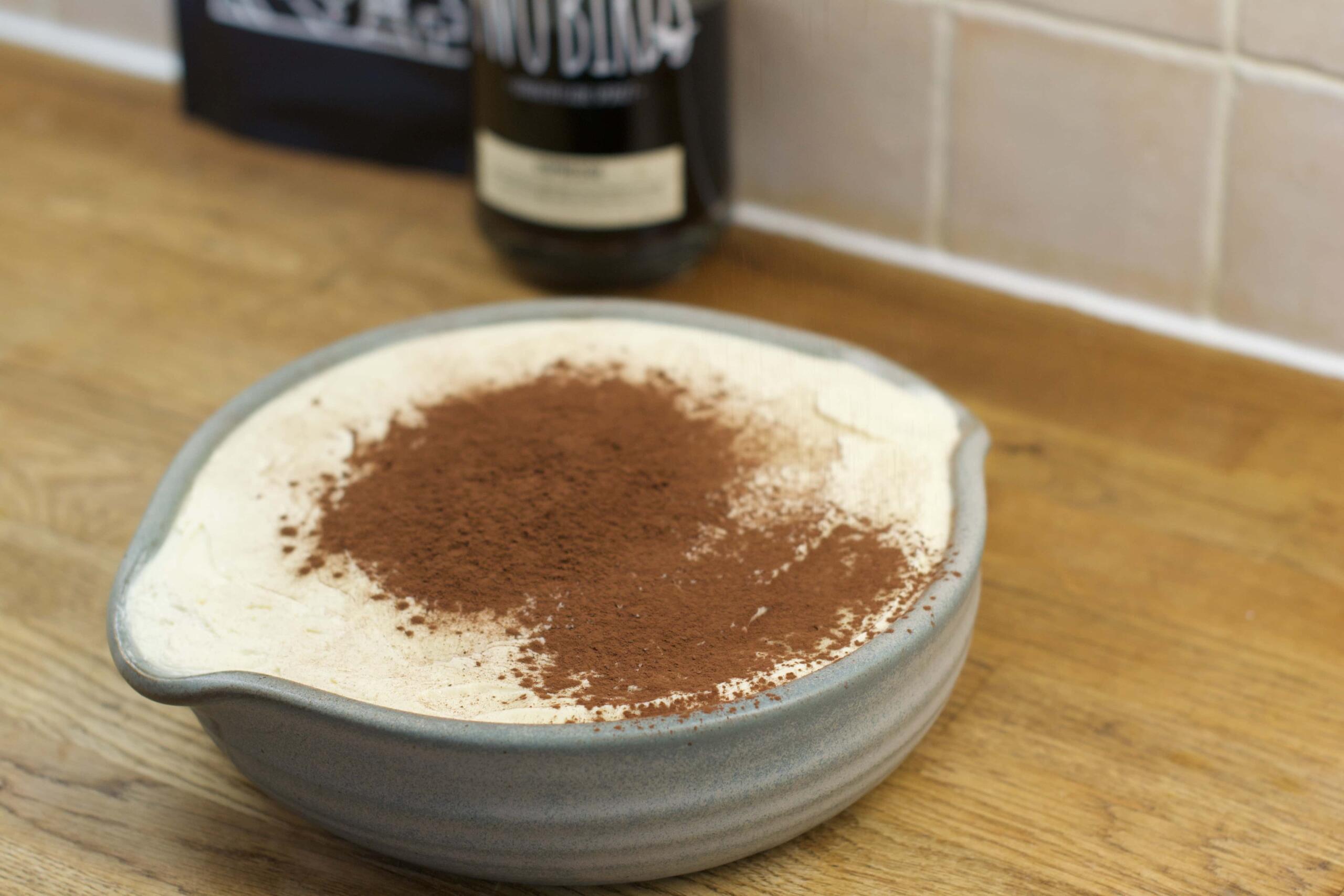 cover the top layer with a coating of cocoa powder and serve