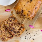 Sliced earl grey tea loaf on chopping board with pink petals