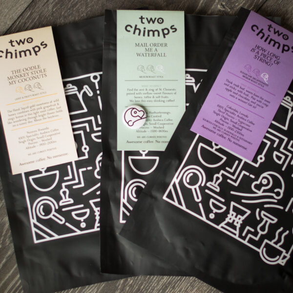 three bags of coffee with two chimps magnet