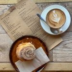 A tasty pastry and a flat white with a beautiful latte art tulip at The Larder Burrough Court