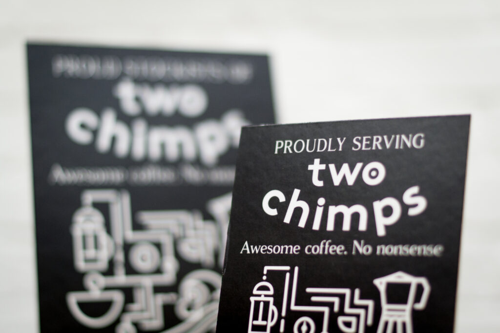 Proudly Serving Two Chimps Coffee Sign