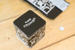 Two Chimps coffee tin and magnet on a table