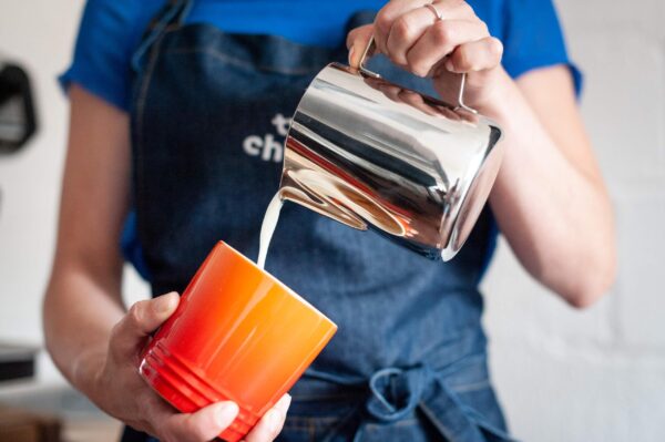 pouring milk into a mug