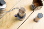 pouring water onto coffee grounds in aeropress