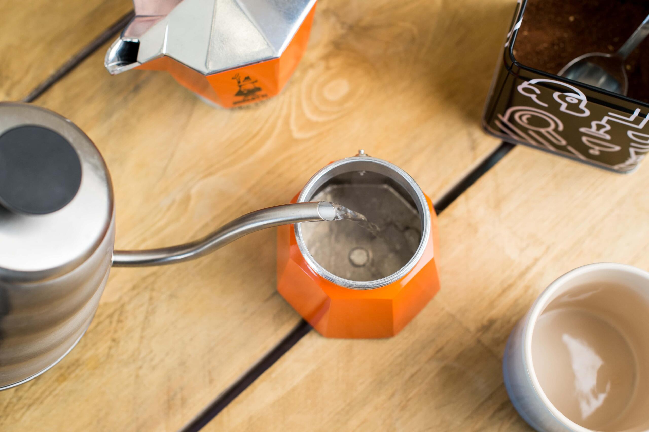 Pouring water into bottom of moka pot 