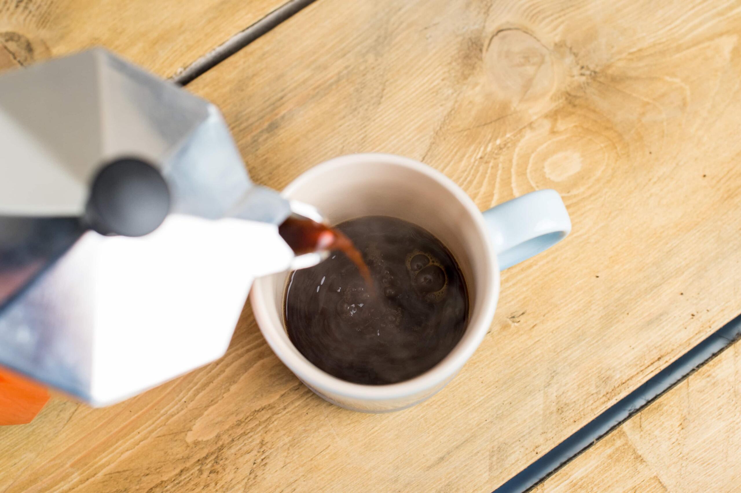 Pouring coffee from moka pot 