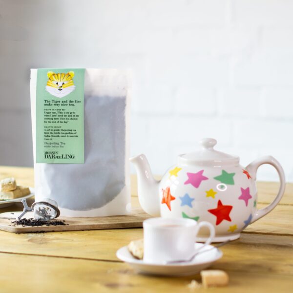 bag of darjeeling tea with a tea cup and teapot