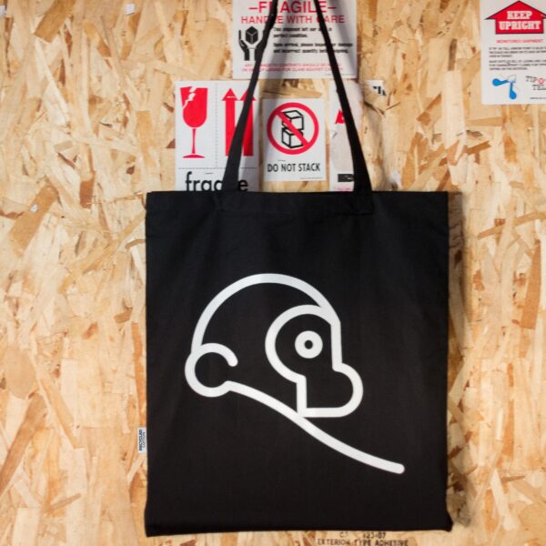 Two Chimps recycled cotton tote bag hanging on a wooden wall
