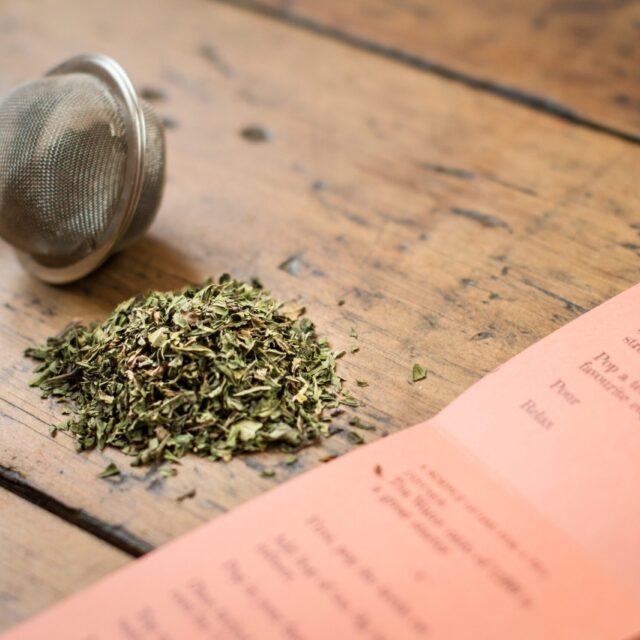 Two Chimps Peppermint tea label with loose tea infuser and loose leaf peppermint tea