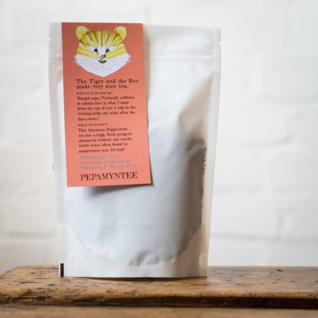 Bag of Two Chimps peppermint tea sits on a wood table