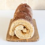 Swiss roll on a wooden chopping board