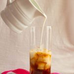 Pouring milk into iced latte