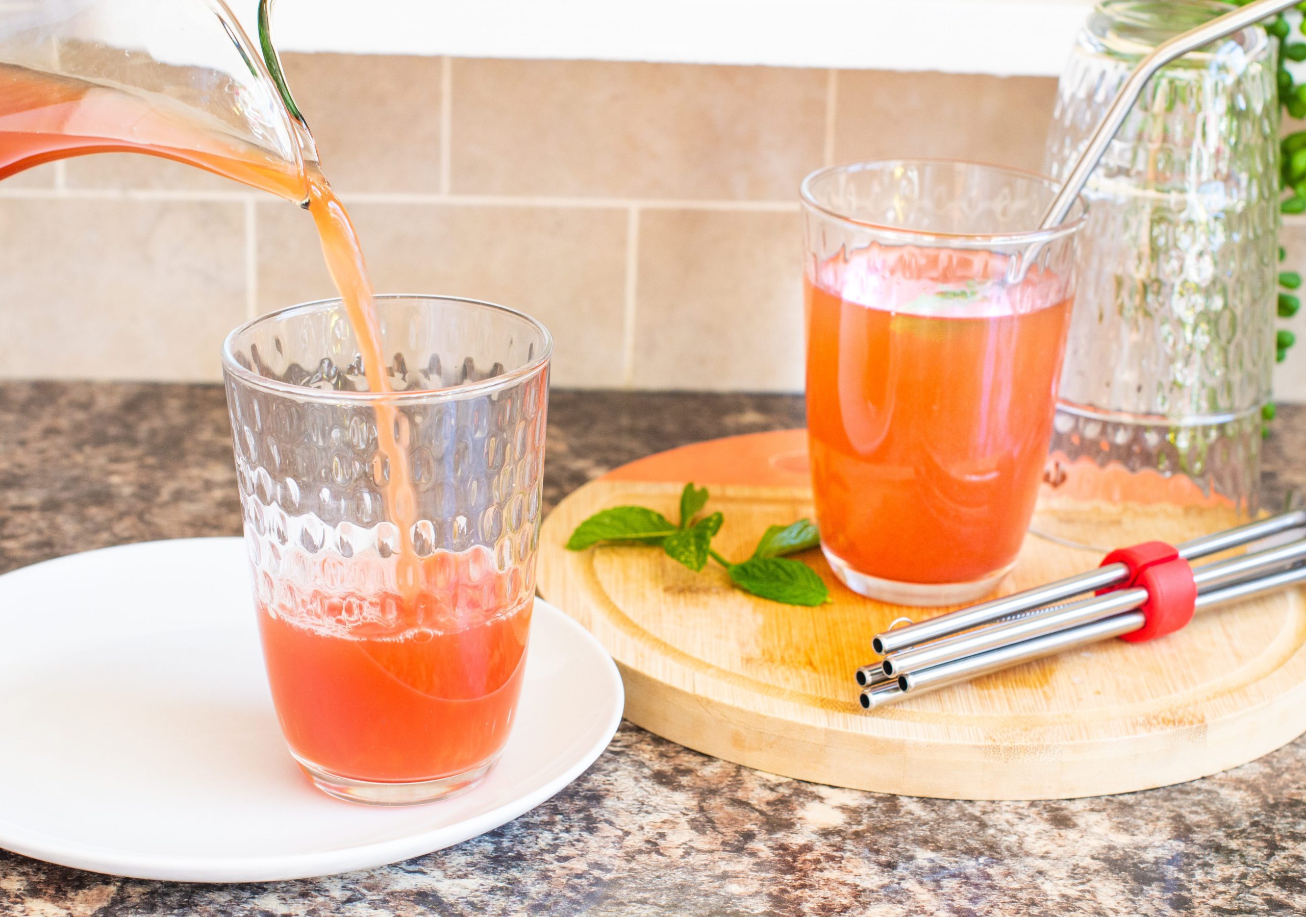 Pouring watermelon iced tea into glasses