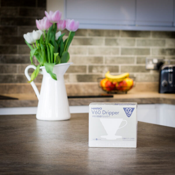 boxed white hario V60 coffee dripper on kitchen worktop available to purchase from the Two Chimps online shop
