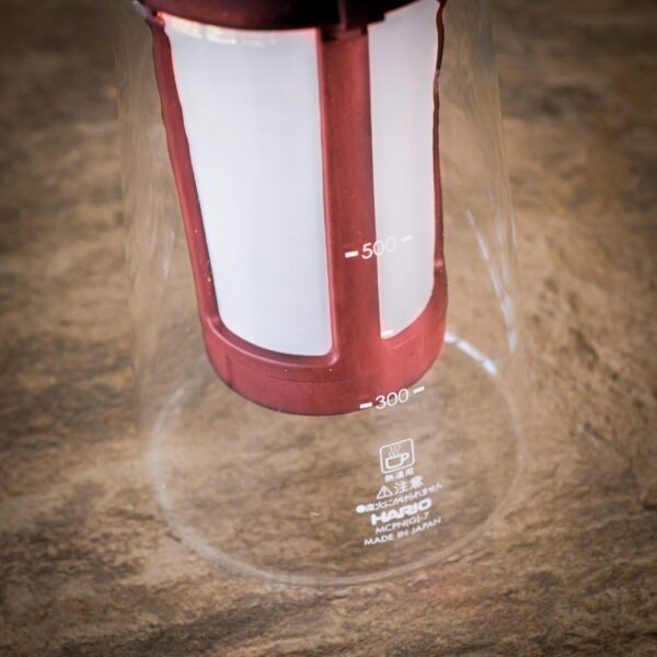 close up of red cold brew coffee pot