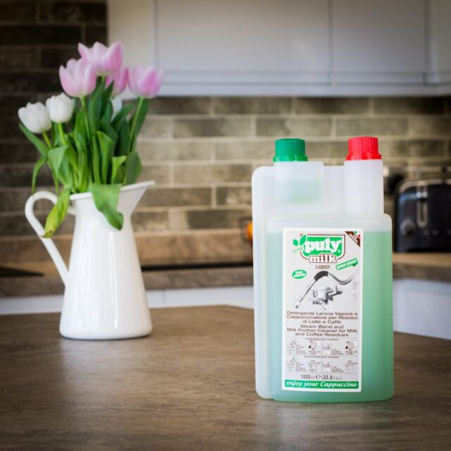 bottle of puly milk frother wand cleaning solution on kitchen worktop