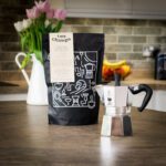 bialetti moka express pot with a bag of two chimps coffee on a kitchen worktop