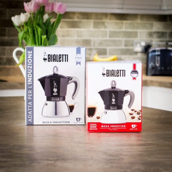 One boxed Bialetti Moka 6 Cup Induction Pot And One 4 Cup Induction Moka Pot On a Kitchen Worktop