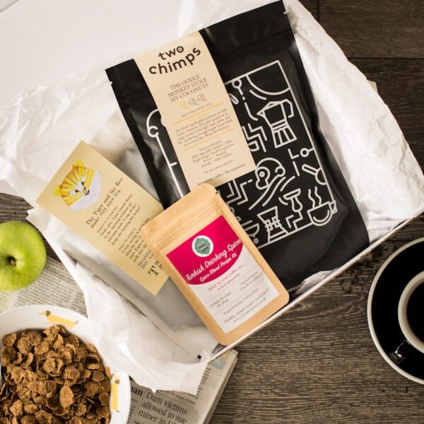 birds eye view of two chimps coffee bag with a bag of loose leaf breakfast tea and spice pouch in a white gift box