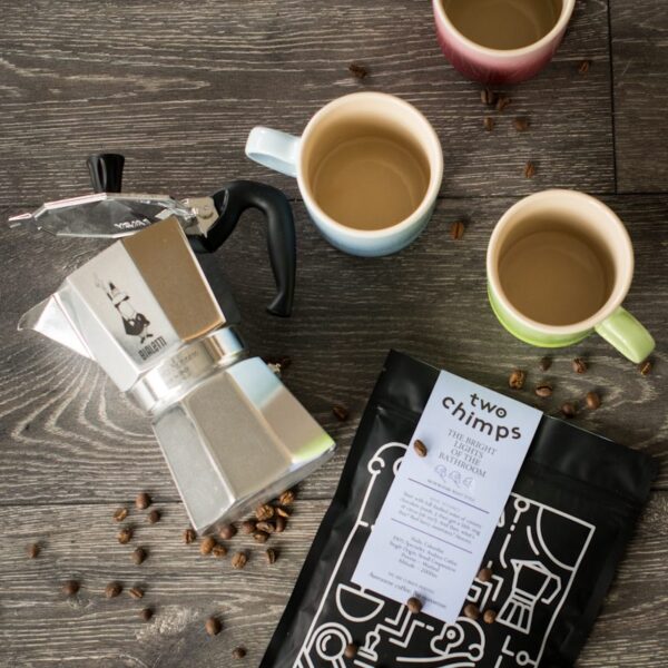 birdseye view of express moka pot with a bag of two chimps coffee on a wooden table