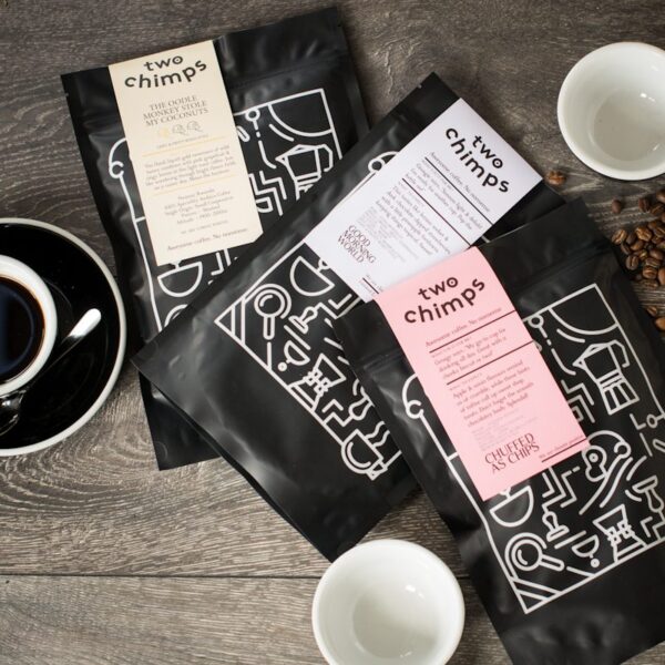 three bags of two chimps coffee on wooden table