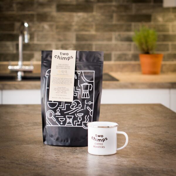 two chimps enamel mug with bag of coffee on kitchen worktop