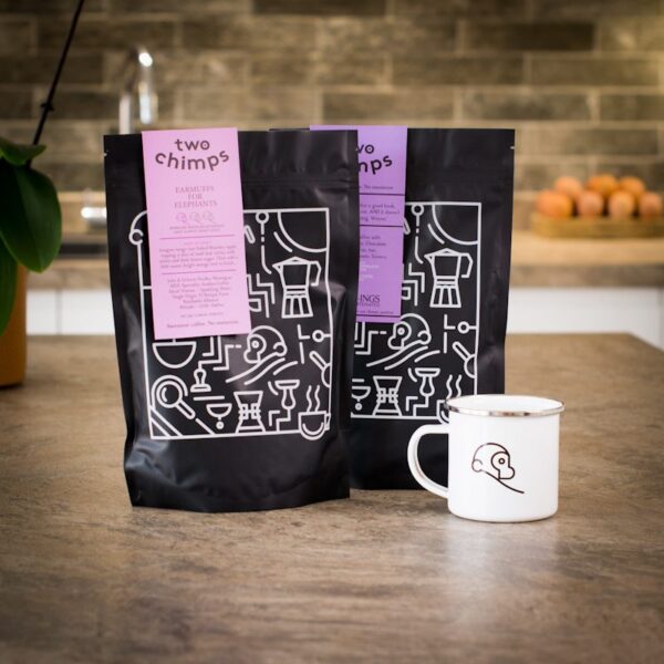 two decaf two chimps coffee bags with enamel two chimps mug on kitchen worktop
