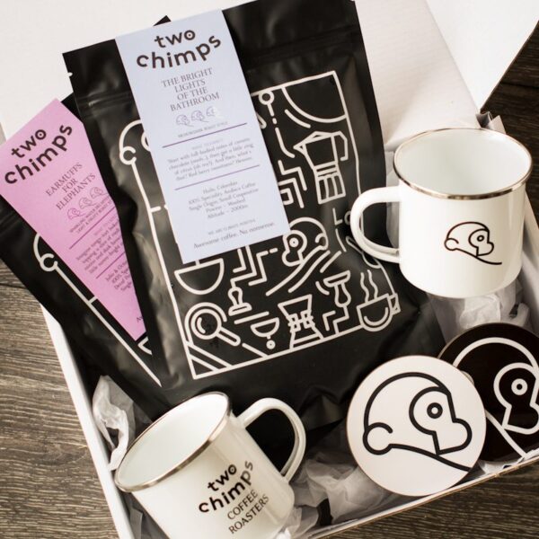 two bags of two chimps coffee with two mugs and two coasters in a white gift box