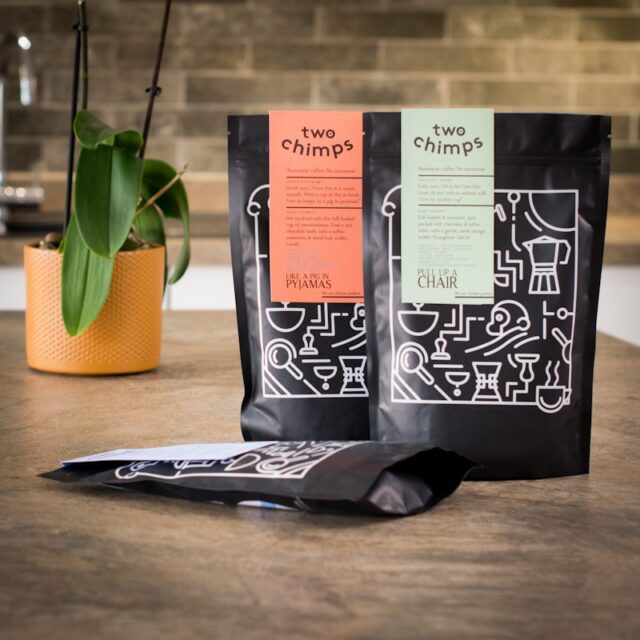 three bags of darker roasted two chimps coffee on a kitchen worktop