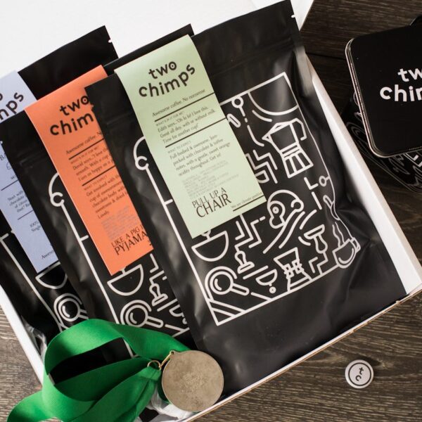 birds eye view of three bags of two chimps coffee in a white gift box