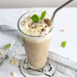 peppermint iced mocha with mint leaves and mini whisk